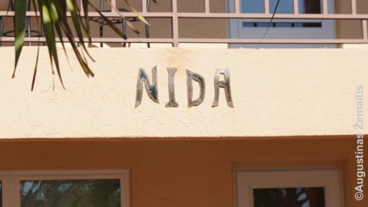 Apartment building 'Nida' sign close-up