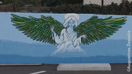 Oen of many murals by Rolandas Dabrukas in parish territory. There are three such angels next to each other with wings in eaach of the colors of the Lithuanian flag