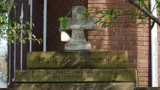 Memorial to the former priest outside of the church