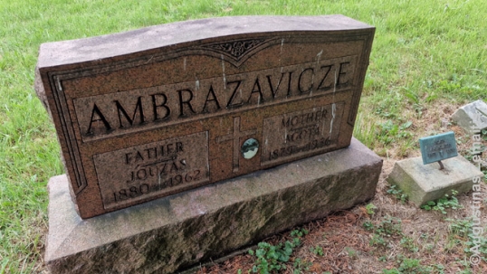 As was common in the times, Lithuanian names changed in America. In this case, the same woman's name is written differently on different memorials on her own grave; while the main gravestone has hear as "Agota Ambrazevicze", the smaller post has her as "Agata Ambrazatas". Likely real name was "Agota Ambrazevičienė" or "Agota Ambrazaitienė".